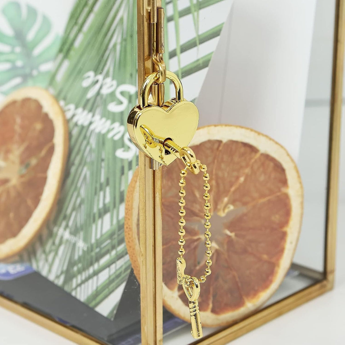 Heart-shaped decorative lock on gold-tone card box