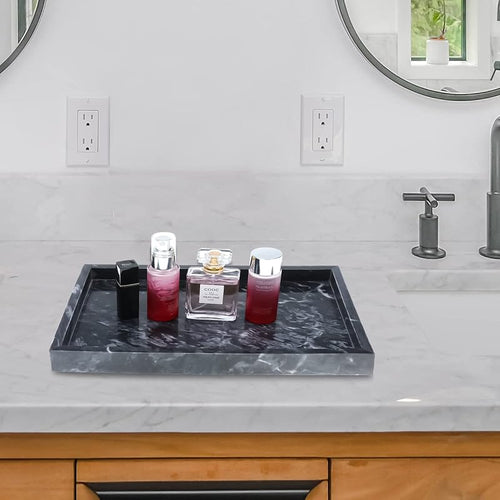 Black marble-pattern catchall tray beside a bathroom sink; bottles and decor not included.